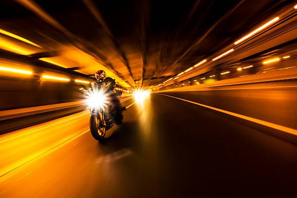 Man riding a bike in the tunnel at night. High ISO.